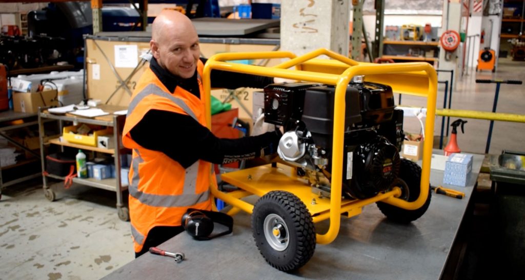 Photo of YRCO serviceman working on a generator